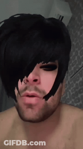 A Man With A Nose Ring Has A Black Haircut GIF