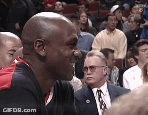 A Man With A Nose Ring Is Laughing In Front Of A Crowd GIF
