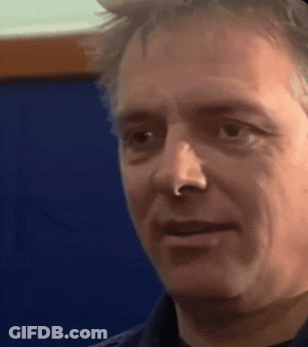 A Man With A Nose Ring Looks At The Camera GIF
