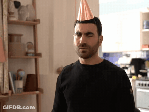 A Man With A Party Hat On His Head GIF