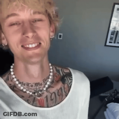 A Man With A Pearl Necklace Around His Neck Has A Tattoo On His Chest That Says " 1995 " GIF