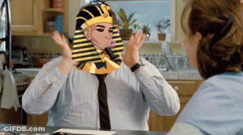 A Man With A Pharaoh 'S Hat On His Head Talks To A Woman GIF