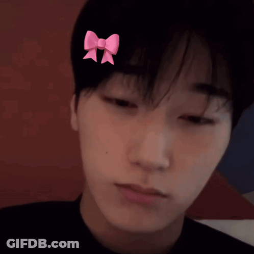 A Man With A Pink Bow On His Head GIF