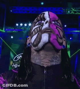 A Man With A Pink Mask On His Face Is Looking At The Camera GIF