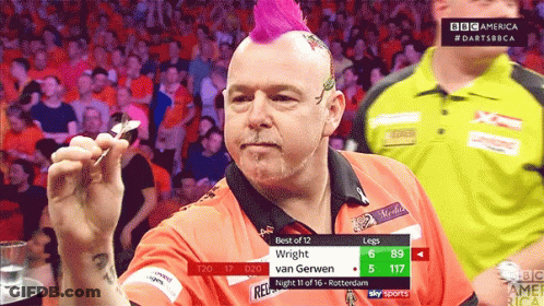 A Man With A Pink Mohawk Is Holding A Dart GIF