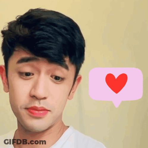 A Man With A Pink Speech Bubble With A Red Heart On It GIF