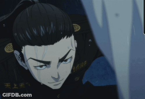 A Man With A Ponytail And Chinese Writing On His Jacket GIF