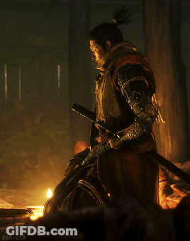 A Man With A Ponytail Is Holding A Sword In His Hand GIF