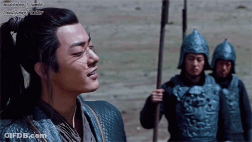 A Man With A Ponytail Is Standing In Front Of A Group Of Soldiers With Their Helmets On GIF
