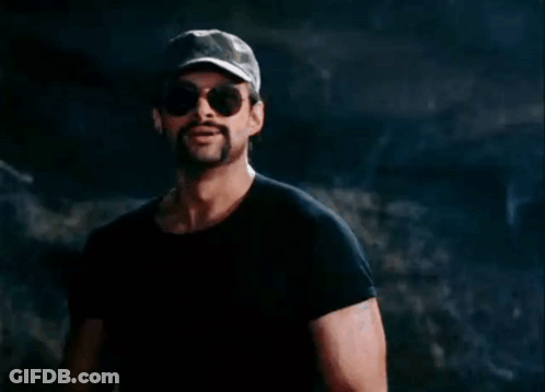 A Man With A Ponytail Wearing Sunglasses And A Hat GIF