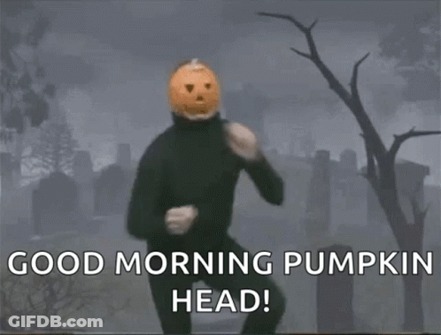 A Man With A Pumpkin Head Is Dancing In A Cemetery GIF