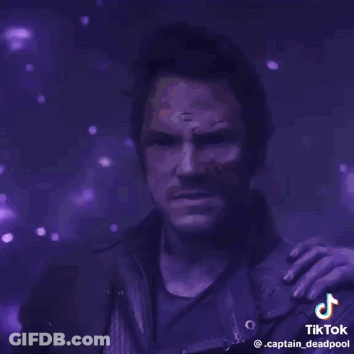 A Man With A Purple Background And The Words Guns Of The Galaxy On It GIF