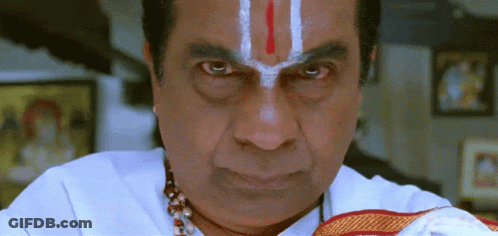 A Man With A Red And White Stripe On His Forehead Is Looking At The Camera GIF