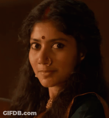 A Man With A Red Circle On His Forehead Looks At The Camera GIF