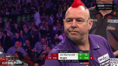 A Man With A Red Mohawk Stands In Front Of A Crowd Watching A Match Between Van Barneveld And Wright GIF