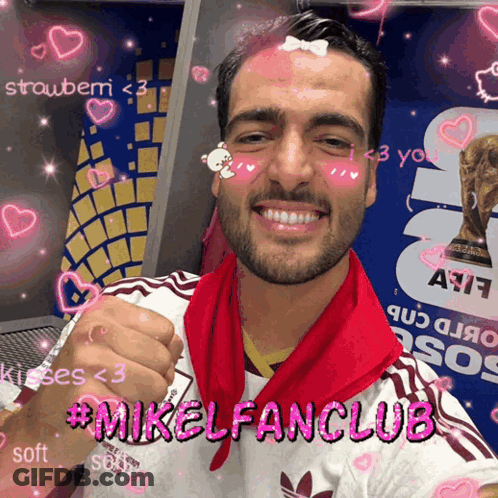 A Man With A Red Scarf Around His Neck And The Words #Mikelfanclub On His Chest GIF