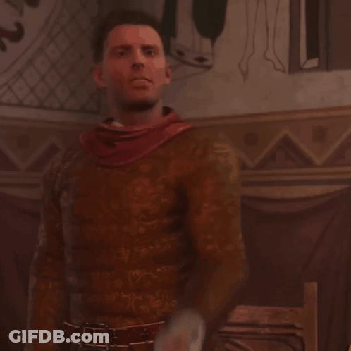 A Man With A Red Scarf Around His Neck Is Standing In Front Of A Wall GIF