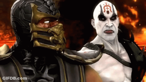 A Man With A Red Symbol On His Forehead Is Standing Next To A Man With A Mask On GIF