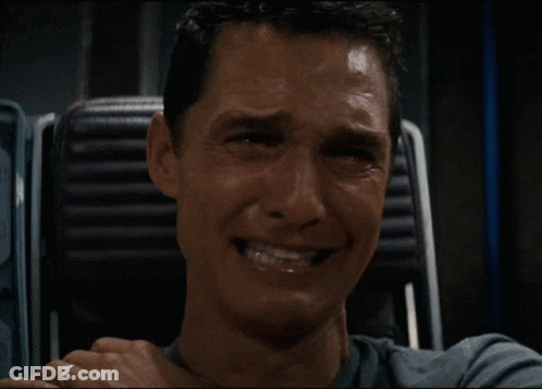 A Man With A Ring On His Finger Covering His Mouth With His Hand GIF