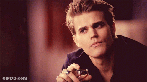 A Man With A Ring On His Finger Holds A Glass GIF