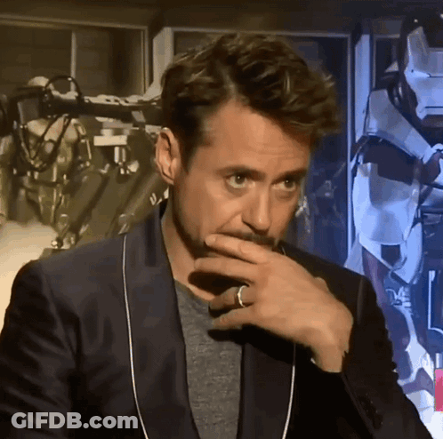 A Man With A Ring On His Finger Is Covering His Mouth With His Hand GIF