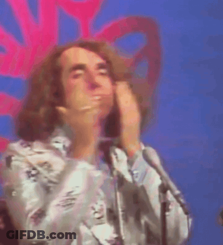 A Man With A Ring On His Finger Is Covering His Mouth With His Hands GIF