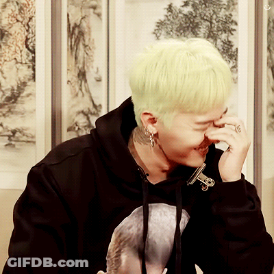 A Man With A Ring On His Finger Is Covering His Nose With His Hand GIF