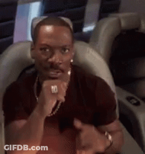 A Man With A Ring On His Finger Is Giving A Thumbs Up . GIF