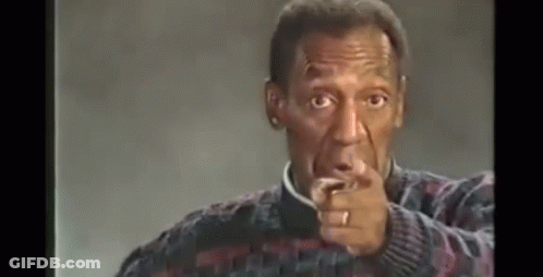 A Man With A Ring On His Finger Is Pointing At The Camera . GIF