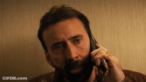 A Man With A Ring On His Finger Is Talking On A Phone GIF