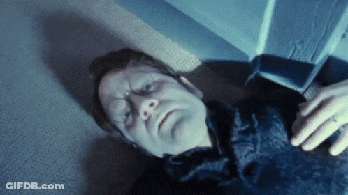 A Man With A Ring On His Finger Laying On The Floor GIF