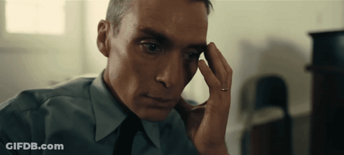 A Man With A Ring On His Finger Looks At Something GIF