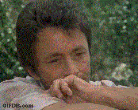 A Man With A Ring On His Finger Looks At The Camera GIF