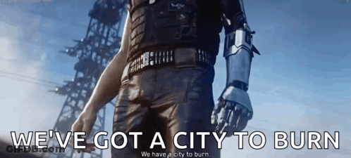 A Man With A Robot Arm Is Walking In Front Of A Building With The Words `` We 'Ve Got A City To Burn '' GIF