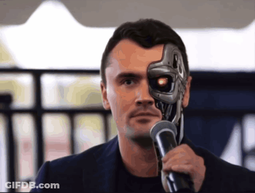 A Man With A Robotic Face Holds A Microphone In Front Of His Face GIF