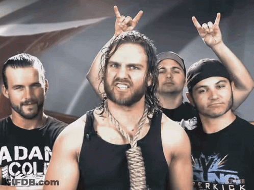 A Man With A Rope Around His Neck Is Wearing A Shirt That Says " Adam Cole " GIF