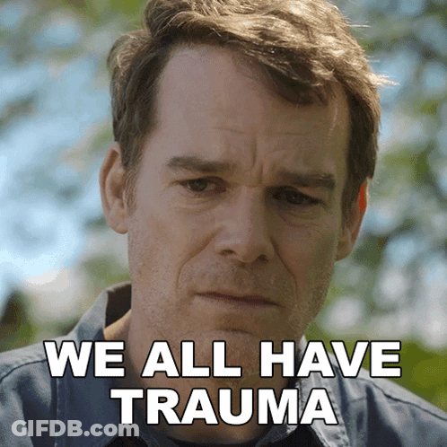 A Man With A Sad Look On His Face And The Words " We All Have Trauma " Behind Him GIF