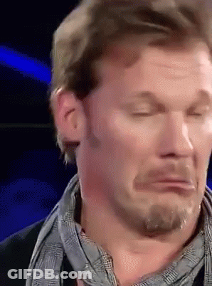 A Man With A Scarf Around His Neck Is Making A Funny Face With His Eyes Closed GIF