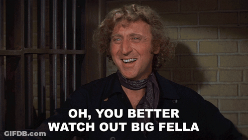 A Man With A Scarf Around His Neck Is Smiling And Says Oh You Better Watch Out Big Fella GIF