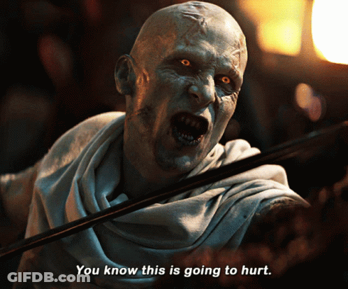 A Man With A Scarf Around His Neck Says You Know This Is Going To Hurt GIF