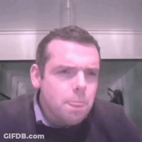 A Man With A Serious Look On His Face Is Wearing A Sweater GIF