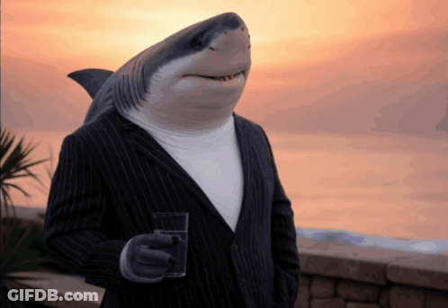 A Man With A Shark Head Is Holding A Glass Of Water GIF