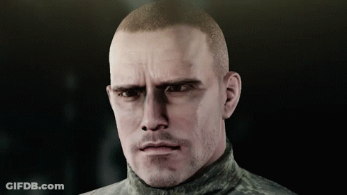 A Man With A Shaved Head And A Beard Looks At The Camera GIF