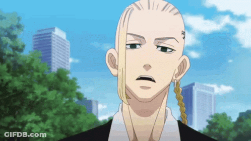 A Man With A Shaved Head And Long Hair Is Standing In Front Of A City Skyline . GIF