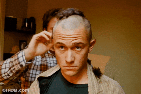 A Man With A Shaved Head Is Getting His Hair Cut By Another Man GIF