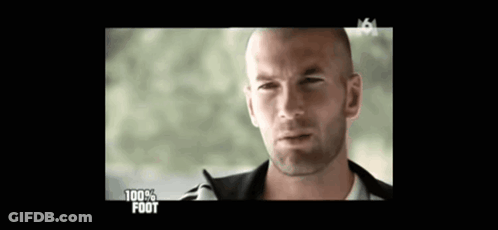 A Man With A Shaved Head Is On A Television Screen With The Words 100 % Foot On It GIF