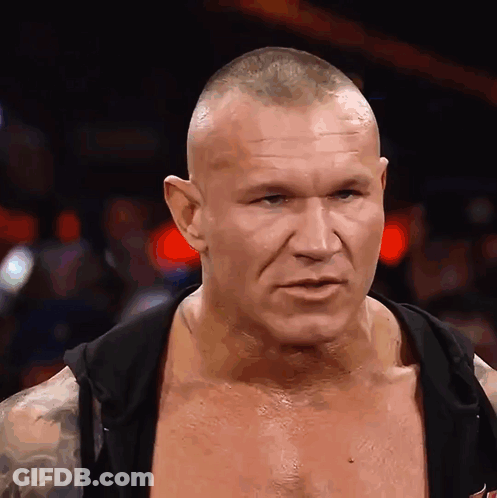 A Man With A Shaved Head Is Wearing A Black Hoodie GIF