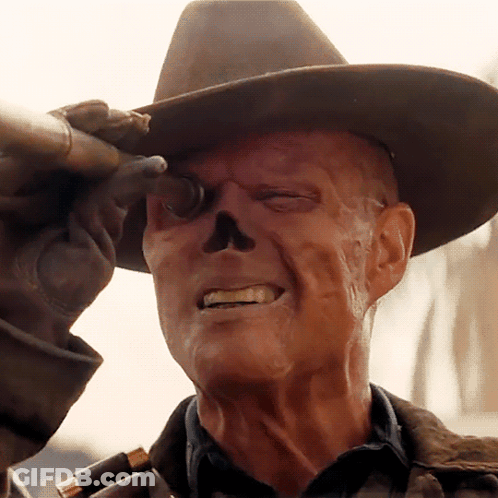 A Man With A Skull Painted On His Face Is Wearing A Cowboy Hat And Holding A Gun GIF