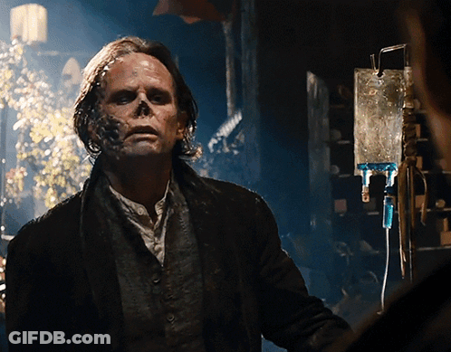 A Man With A Skull Painted On His Face Stands In Front Of A Drip GIF