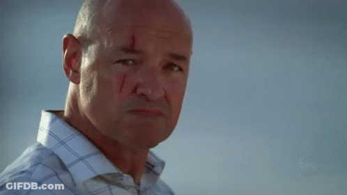 A Man With A Slice Of Orange In His Mouth Looks At The Camera With A Blurred Background That Says Fox GIF